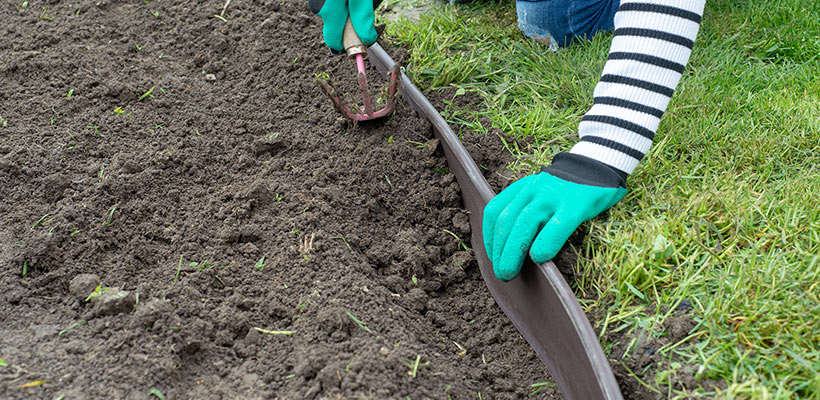 Plastic or rubber edging comes in rolls and is pressed into a narrow trench, offering nice curves.