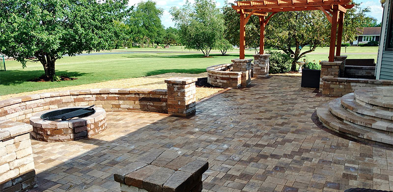 Spacious Backyard Retreat: Custom Brick Patio with Fire Pit & Pergola